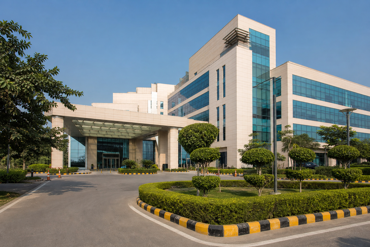 Modern hospital building with a landscaped approach road